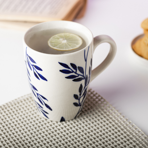 White Color Ceramic Coffee Mug with Blue Leaves and Branches Design, a product by The Golden Theory