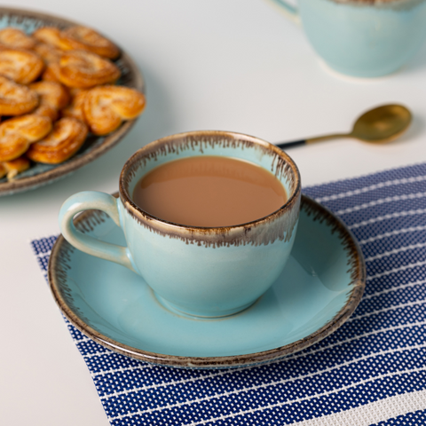 Light Blue Color Cup and Saucer with Brown Drops Border, a product by The Golden Theory